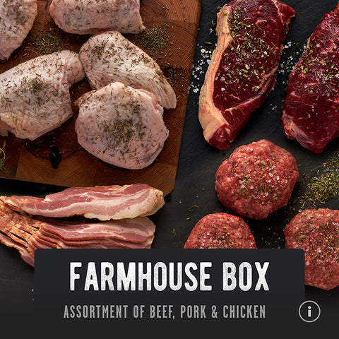 REP Farmhouse Box with primal blend grass-fed beef, pasture raised chicken, pasture raised pork and nutrient-dense regenerative farmed meats. They are sitting on a cutting board and black background and seasoned with spices.