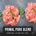 Pastured ground pork organ blend with visible pieces of liver and heart, garnished with rosemary sprigs on a stone surface. REP Provisions regeneratively farmed pork.