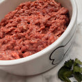 Raw Pet Power Blend meat topper in a white dog bowl