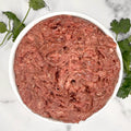 Bowl of raw Pet Power Blend meat topper with fresh parsley